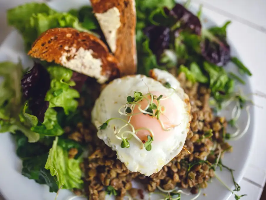 Fried egg over a green salad